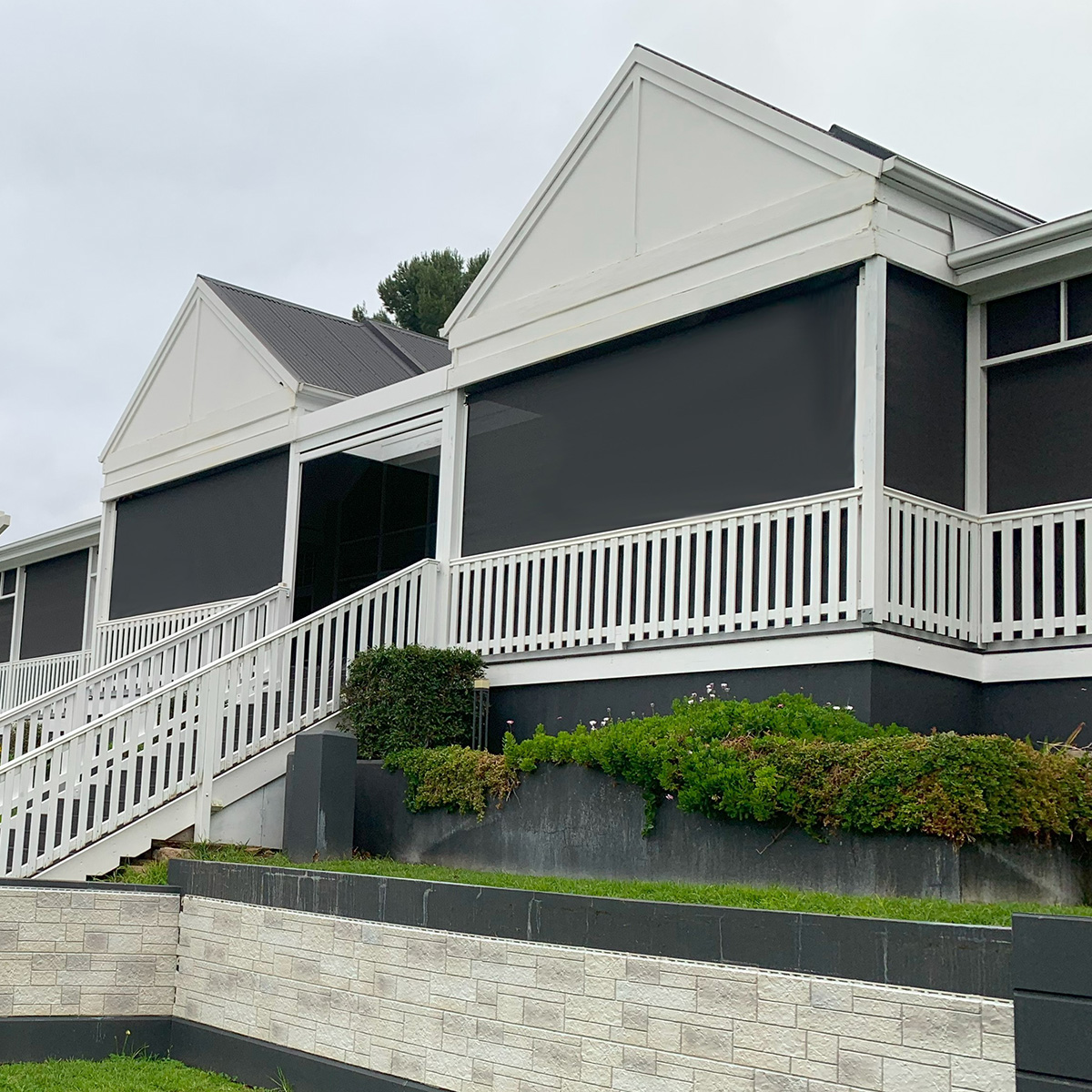 Black outdoor Privacy Bl;inds installed to large balcony area overlooking pool and backyard