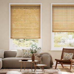 Cedar coloured timber Venetian blinds with beige coloured lounge suit and chair in living room setting