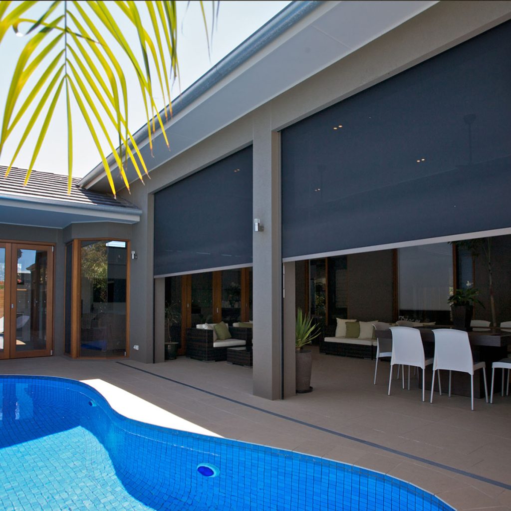 Charcoal Zipscreen Privacy Blinds installed to alfresco area near bright blue pool