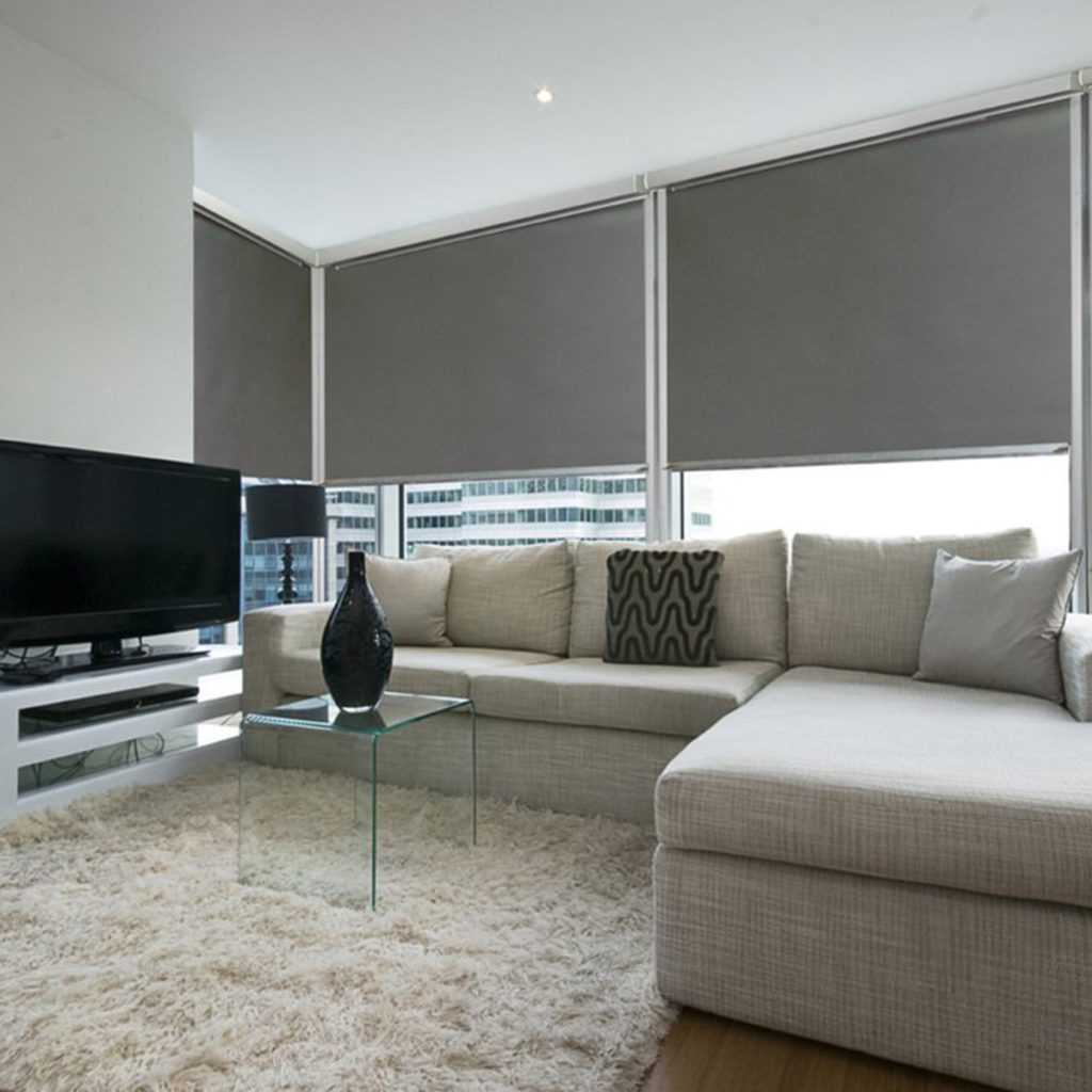 Ziptrak Interior Blinds Installed to large modern living room area featuring a Large Screen TV and L-Shaped Lounge