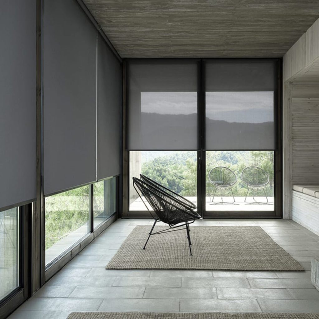 Charcoal translucent roller blinds in minimalistic living room setting