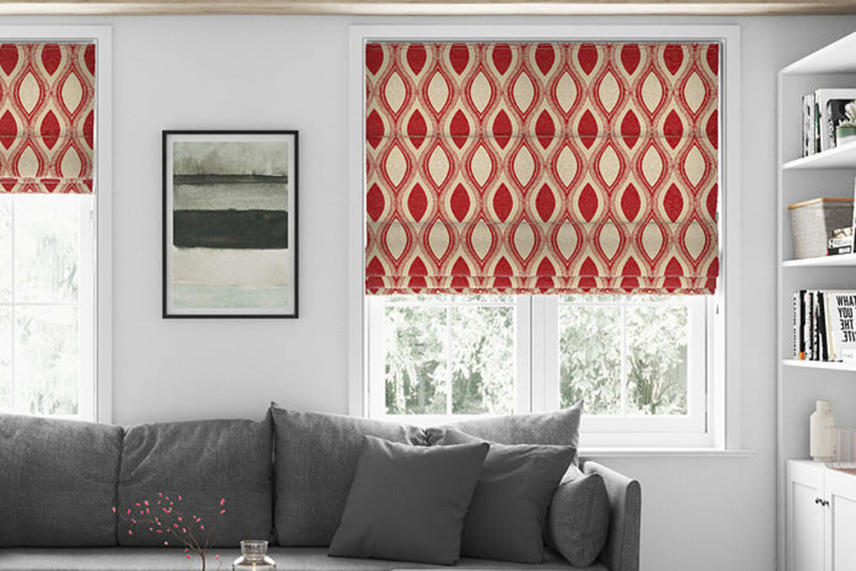 In this image, the roman blinds serve to provide privacy and control the amount of natural light entering the room. The blinds, featuring a sleek, neutral design, help to reduce glare while allowing for a softer diffusion of sunlight. They also contribute to the room's aesthetic by blending seamlessly with the modern decor, ensuring a clean and uncluttered look while enhancing the overall comfort and functionality of the living space.